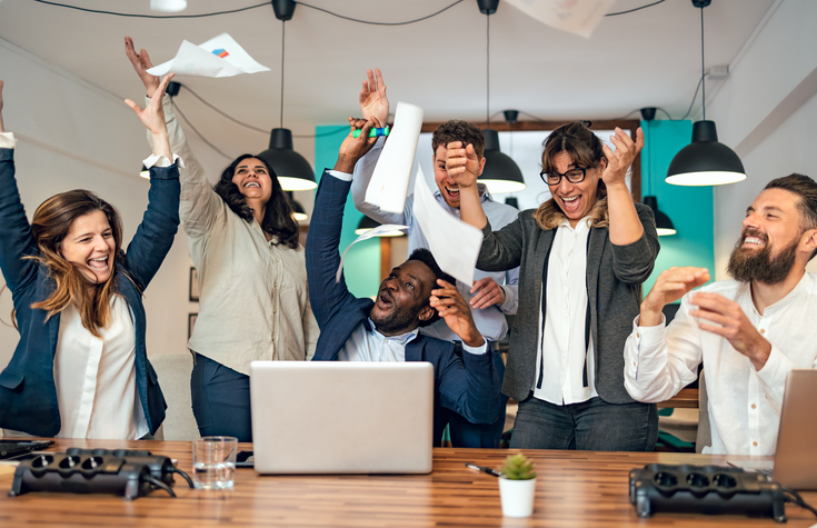 Business team of diverse people celebrating successful work in office